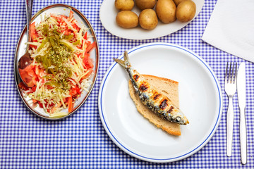 Wall Mural - Grilled sardines with salad, bread and potato