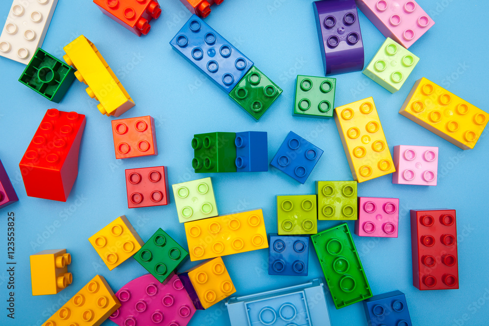 colorful plastic buiding blocks and tiles for kids play on blue ...