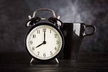 Alarm clock and a cup of coffee