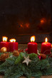 Evergreen fir tree advent garland with burning candles on wooden background, copy space on black background
