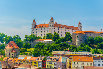 view of the bratislava castle situated on a hill next to the danube river in slovakia