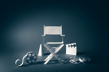 image with vintage texture of a director chair and movie items