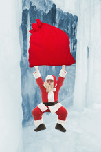 Santa Claus Trains To Lift Very Heavy Bag With Gifts