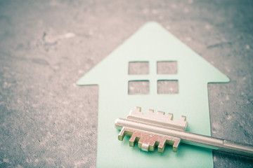 Key and house symbol. Concept image of new property, buying an estate or home security.