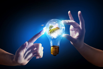 Wall Mural - hand pointing light bulb . mixed media