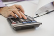 © Dragana Gordic - Men's hands with calculator. Calculation at office
