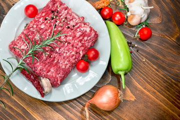 Wall Mural - Fresh raw minced beef - ground beef on white plate and vegetables