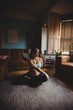 © Wavebreak Media - Pregnant woman performing stretching exercise in living room