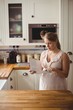 © Wavebreak Media - Pregnant woman reading book in kitchen