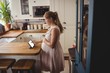 © Wavebreak Media - Pregnant woman using digital tablet in kitchen