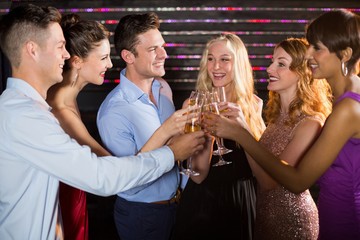 Wall Mural - Group of friends toasting glasses of champagne