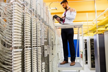 Fototapete - Technician using digital cable analyzer