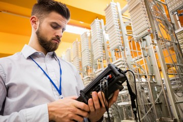 Fototapete - Technician using digital cable analyzer
