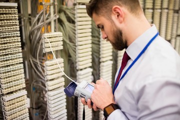 Fototapete - Technician using digital cable analyzer