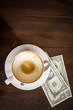 dollars pay for a cup of coffee on wood table