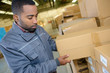 Man selecting boxes in warehouse