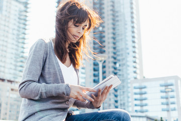 Young Beautiful Woman Using a Digital Tablet Outdoor . New York City US