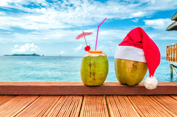 Coconut in Christmas hat and coconut cocktail. Christmas. 