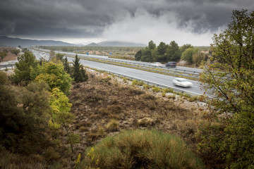 landscape with a highway on a cloudy day in Autumn 