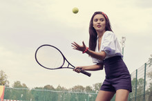 Girl Playing Tennis On Green Court
