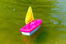 Toy Boat In The Wet Sand Of The Sea. Summer Holidays At Sea. Boat Trips.
