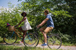 © .shock - Young multiethnic couple having a bike ride in nature