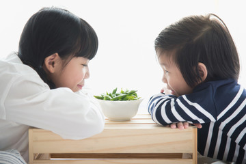 Asian children eating green soybeans