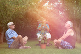 Fototapeta Młodzieżowe - Seniors relaxing with Cannabis plant outdoors