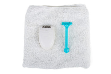 Wall Mural - Electric epilator and disposable razor on the towel. On white, isolated background.