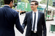 © Sergey Nivens - Two businessmen shaking their hands