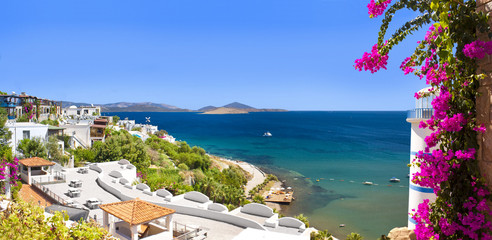 Beautiful flowers frame a sea view of Ortakent, Bodrum, Turkey