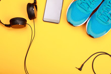 Headphones, Smart Phone And Blue Sneakers On Yellow  Background