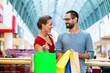 © Kzenon - Man and woman in shopping mall with bags