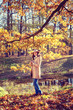 © lizavetta - Woman in autumn park.