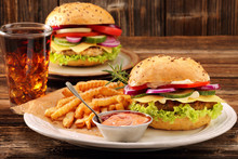 Fresh Tasty Burger With Fries And Drink On Wooden Table