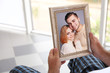 © Africa Studio - Male hands holding photo frame with picture of young couple. Happy memories concept.