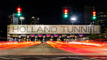 Holland Tunnel toll booth by night. The Holland Tunnel is a highway tunnel under the Hudson River between New York and Jersey City