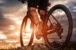 © Aleksey - cyclist man legs riding mountain bike on outdoor trail