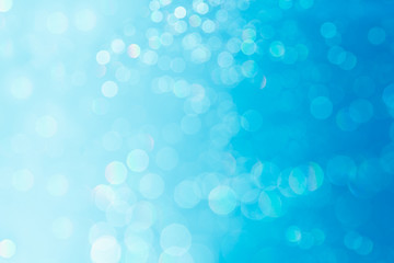 Bokeh soft pastel  blue and white background with blurred  lights. Festive background.