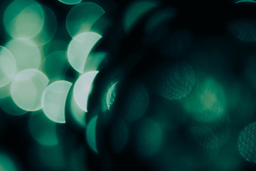 Wall Mural - Bokeh dark green semicircles  on black background. Abstract music background.