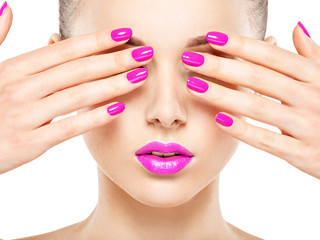 Wall Mural - Close-up face of a beautiful  girl with  purple nails and lips.