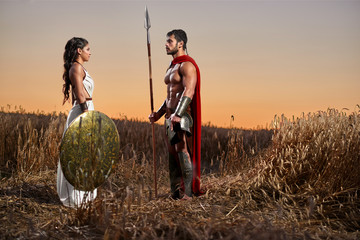 Wall Mural - Spartan warrior and his woman in the field