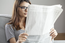 Young Woman Reading Newspaper