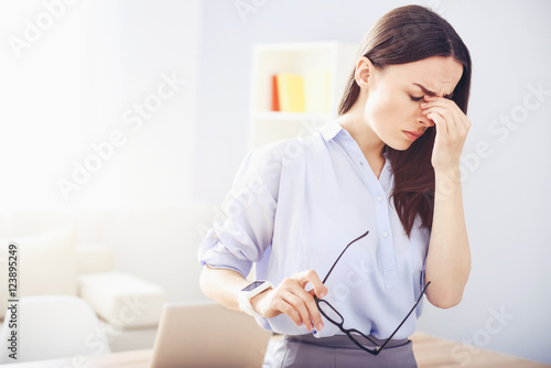 Fotografie, Obraz Tired young woman suffering from migraine.