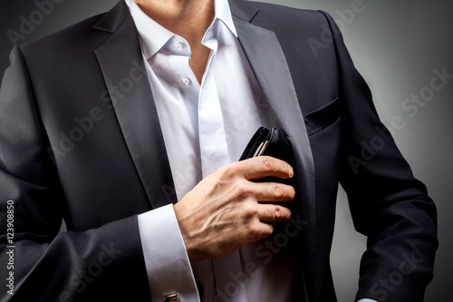 Fotografía Man pulled out of his inside jacket pocket wallet