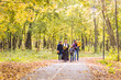 © satura_ - Happy young family spending time together outside in autumn nature.