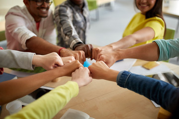 Poster - close up of international students hands fist bump