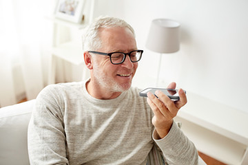 Canvas Print - old man using voice command recorder on smartphone