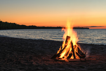 beach bonfire with beautiful sunset sky