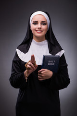 Religious nun in religion concept against dark background